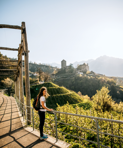 A woman is enjoying the view of Tirolo